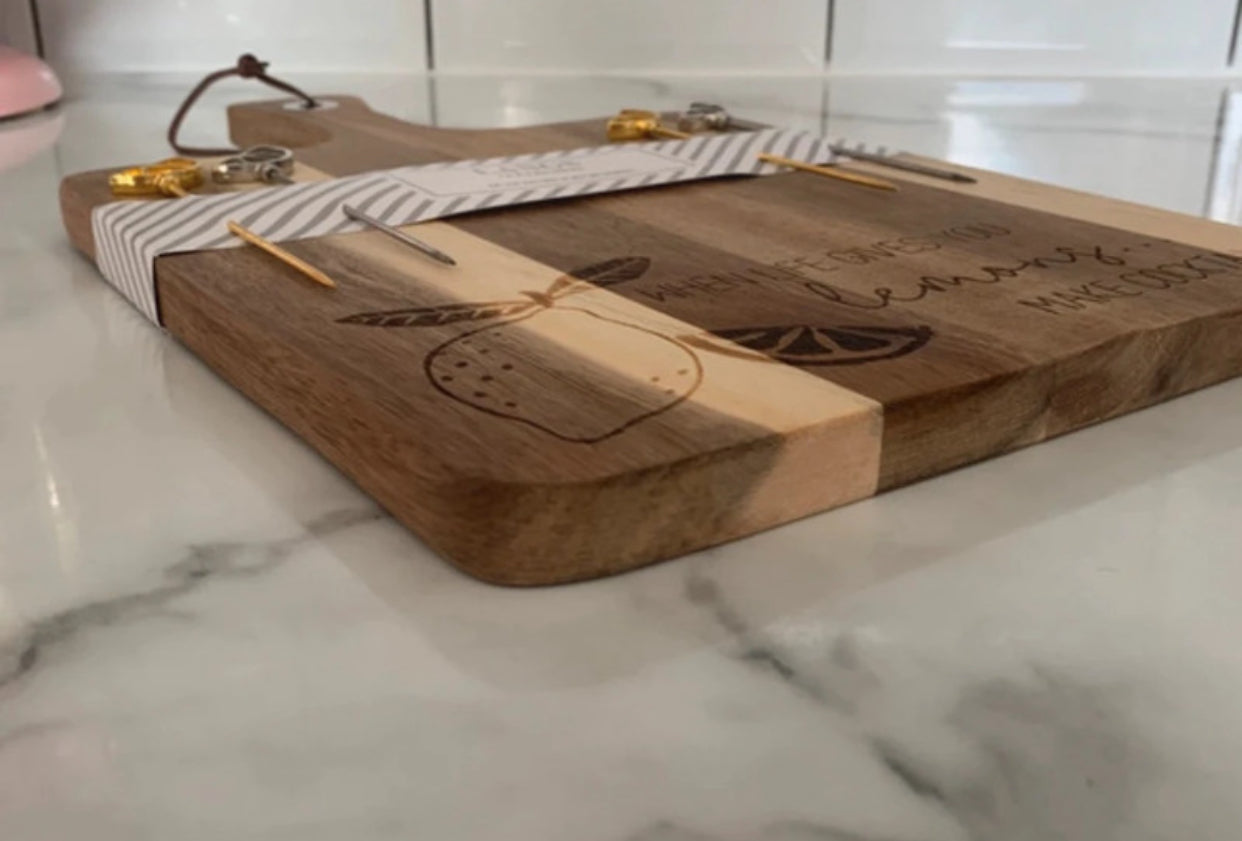 Gorgeous engraved acacia chopping board with lemon picks ‘when life gives you lemons make cocktails'